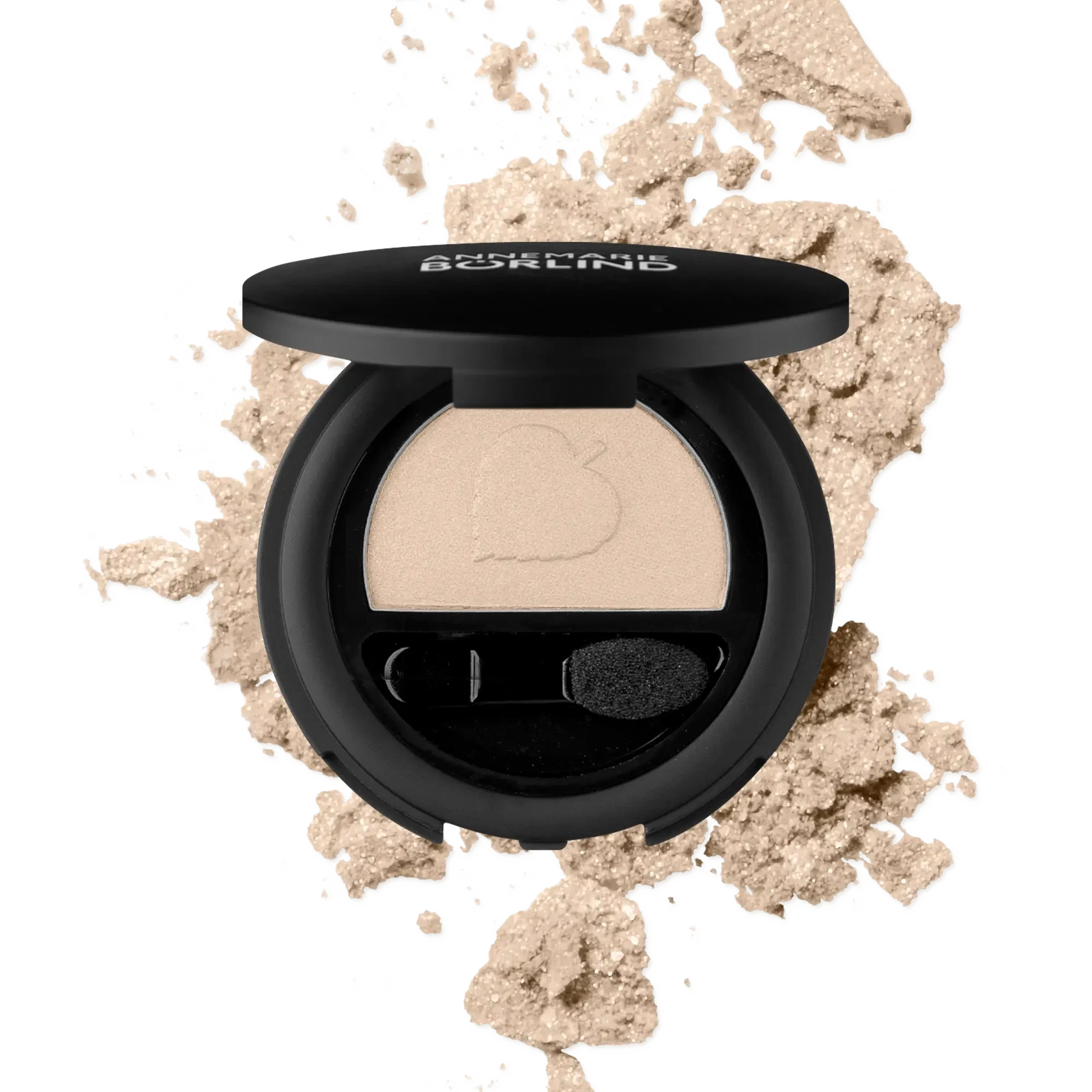 ANNEMARIE BÖRLIND Lidschatten in Beige mit Applikator und losem Puder im Hintergrund