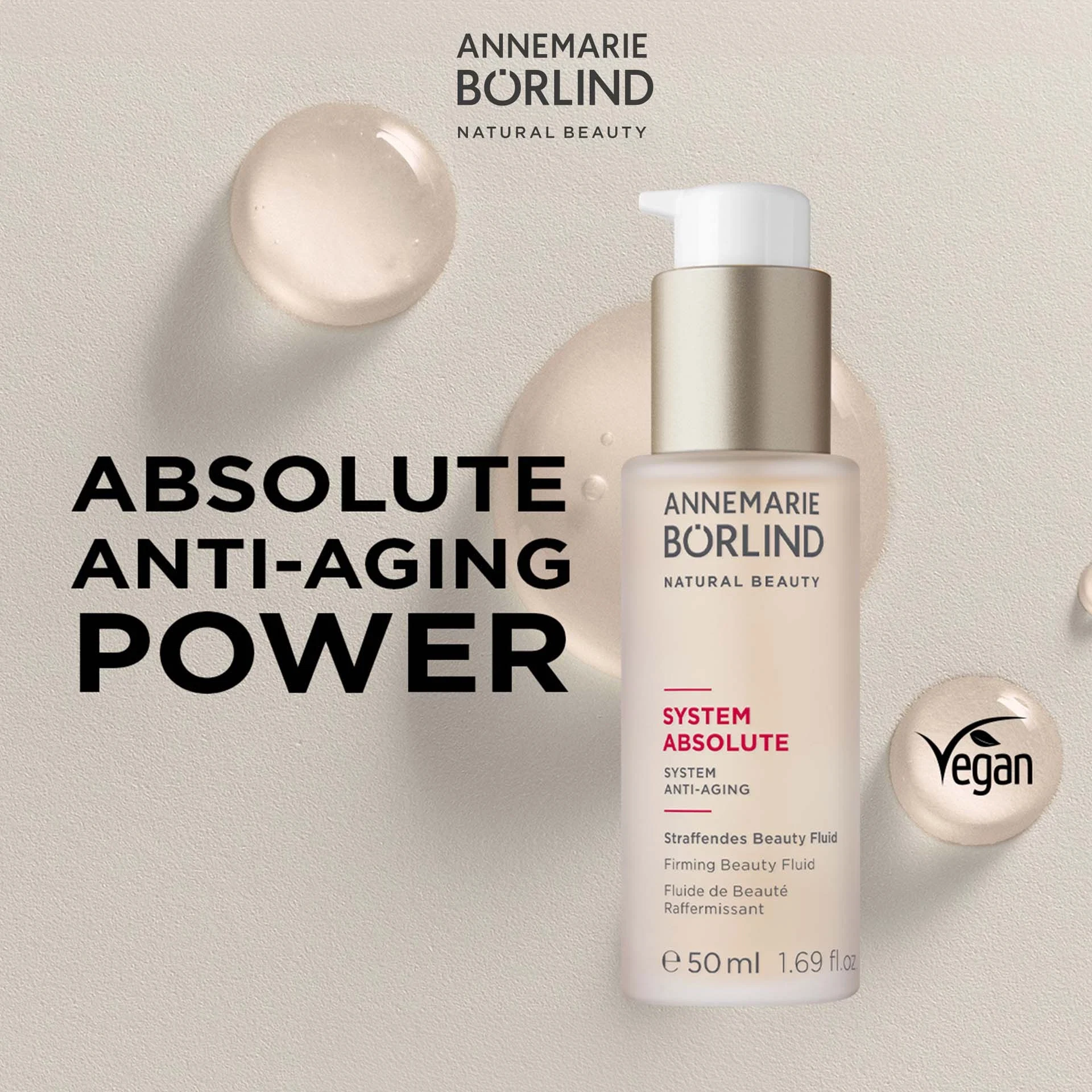 ANNEMARIE BÖRLIND System Absolute Straffendes Beauty Fluid mit Text Absolute Anti-Aging Power vor beigem Hintergrund mit Textur