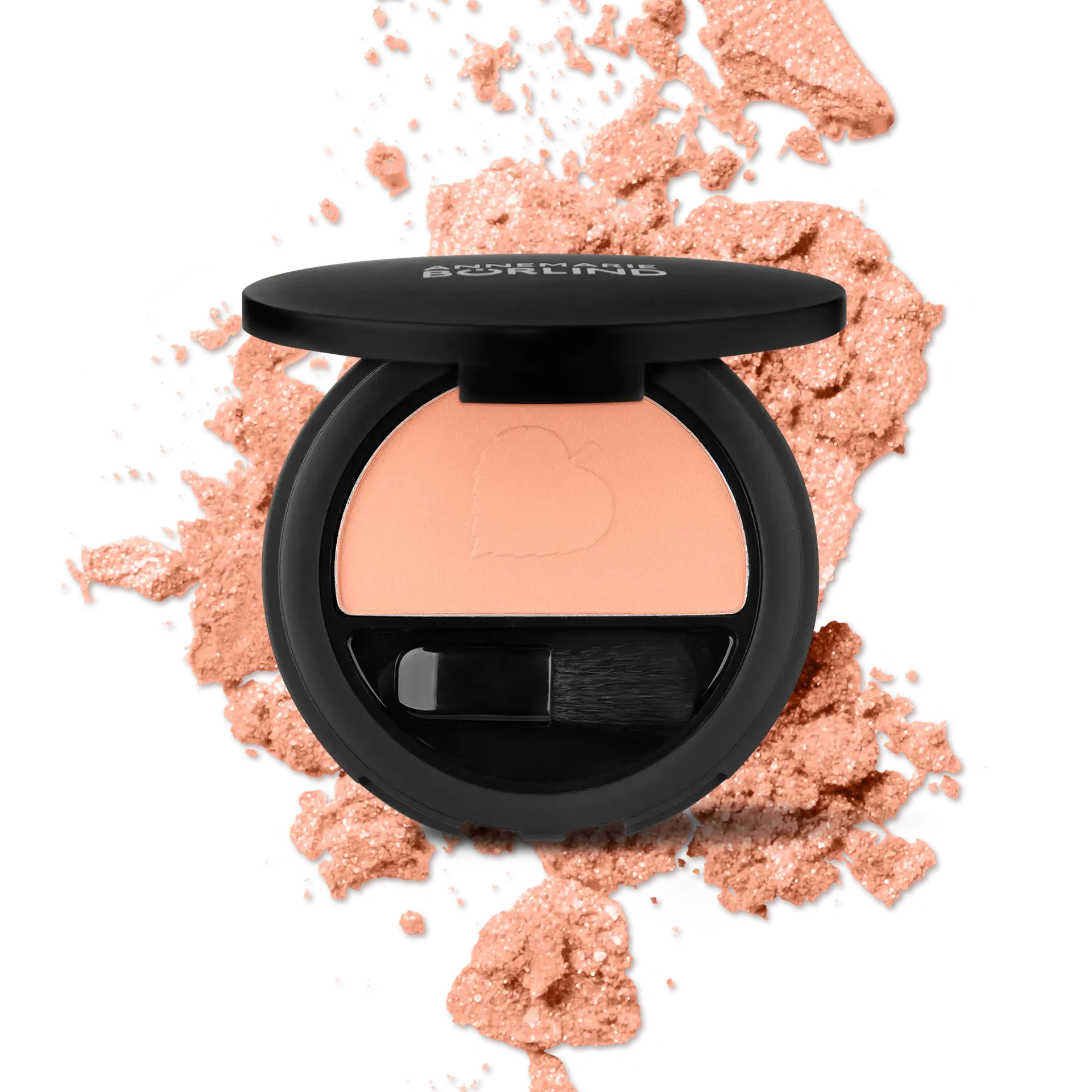 ANNEMARIE BÖRLIND Puderrouge Glowy Peach mit Applikator vor zerriebenem Rouge in Pfirsichton